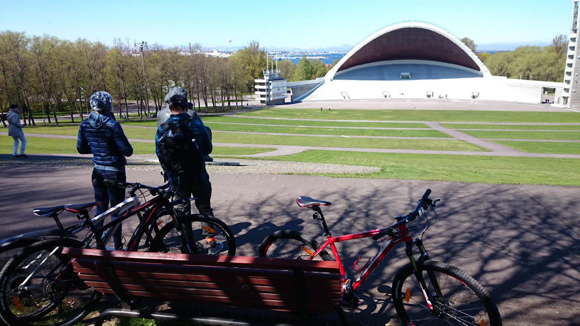 a group of people riding on the back of a bicycle in Tallinn