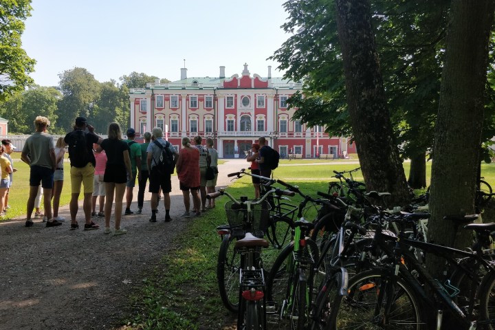 a group of people standing next to a bicycle