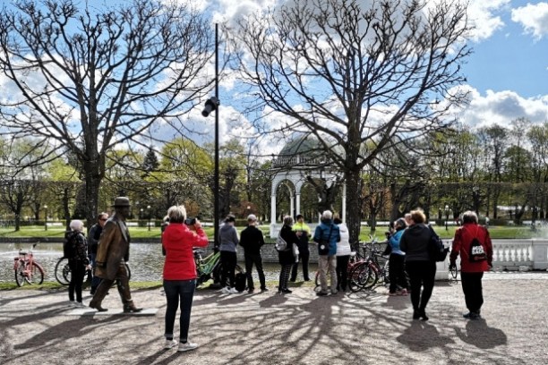 a group of people riding on the back of a bicycle in Tallinn