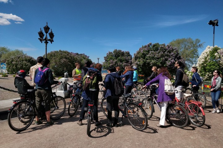 a group of people standing around a bicycle