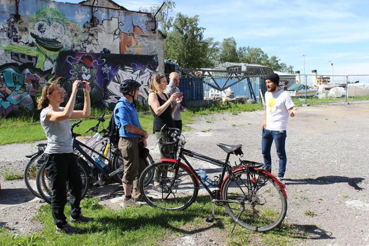 a group of people riding on the back of a bicycle in Tallinn