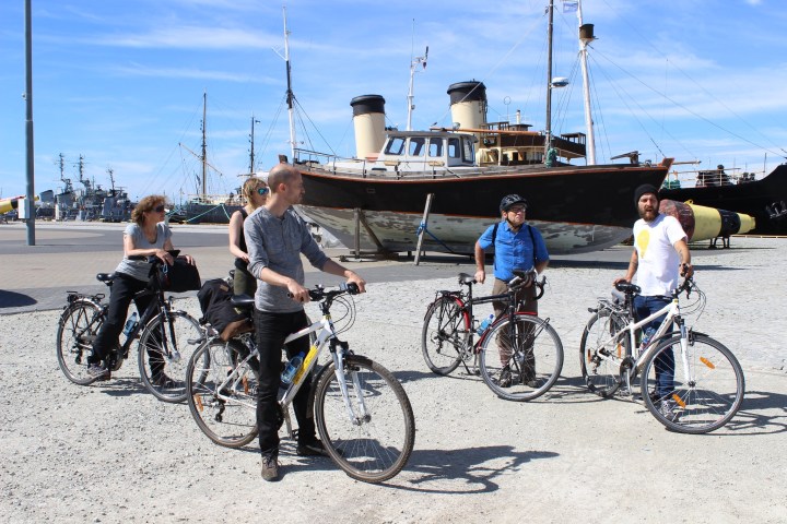 a group of people bringing their bike