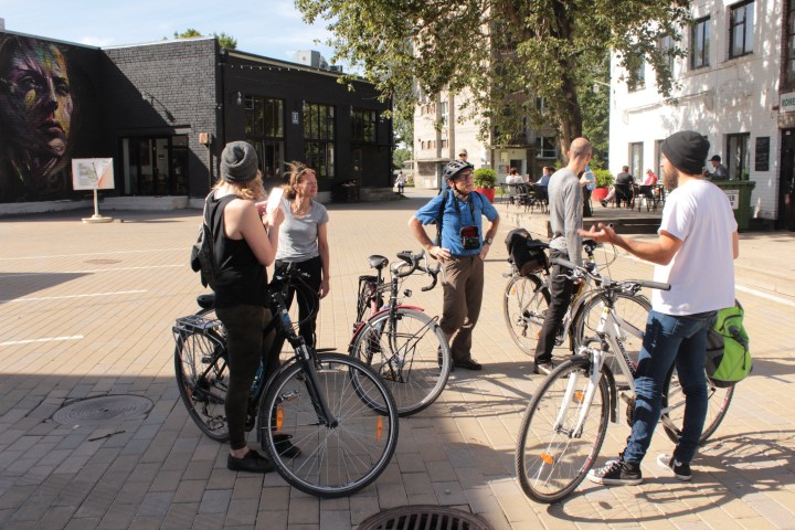 a group of people riding on the back of a bicycle