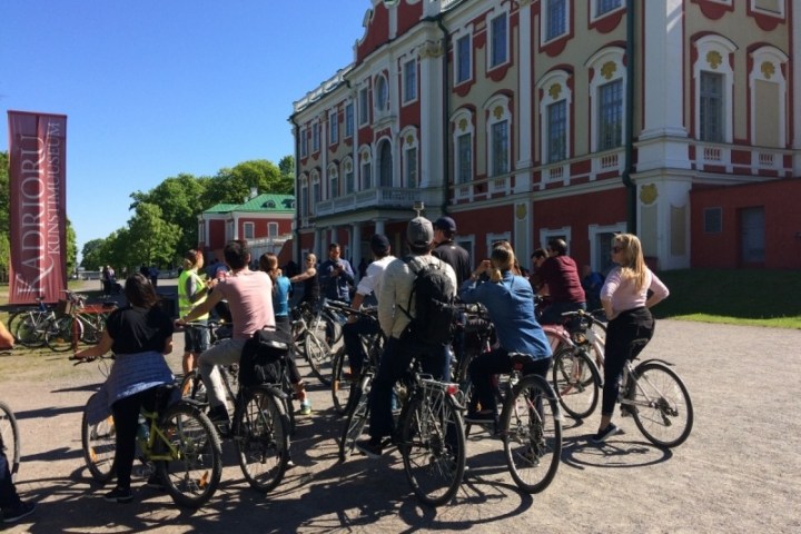 a group of people riding on the back of a bicycle in Tallinn
