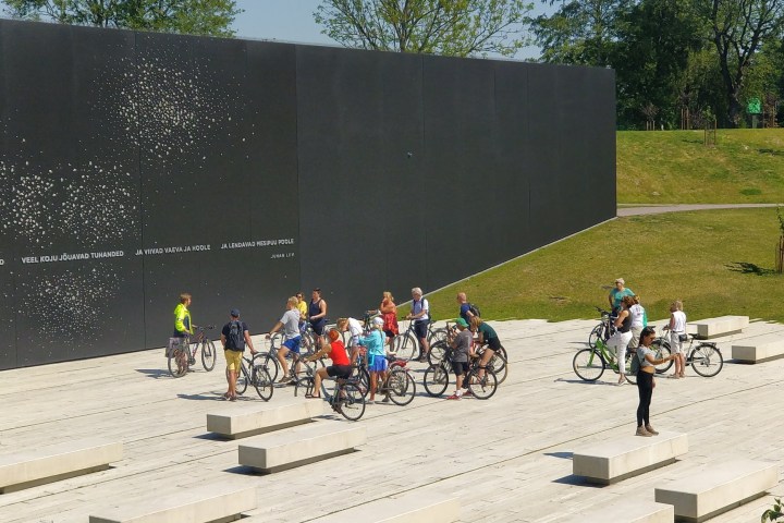 a group of people riding on the back of a bicycle in Tallinn
