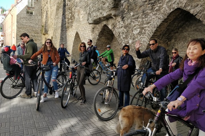 a group of people riding on the back of a bicycle in Tallinn