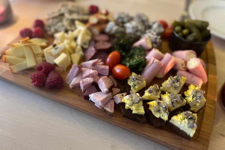 a piece of cake sitting on top of a wooden cutting board