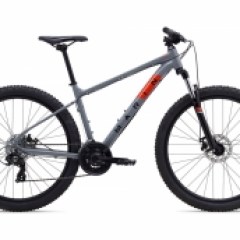 a bicycle leaning against a wall