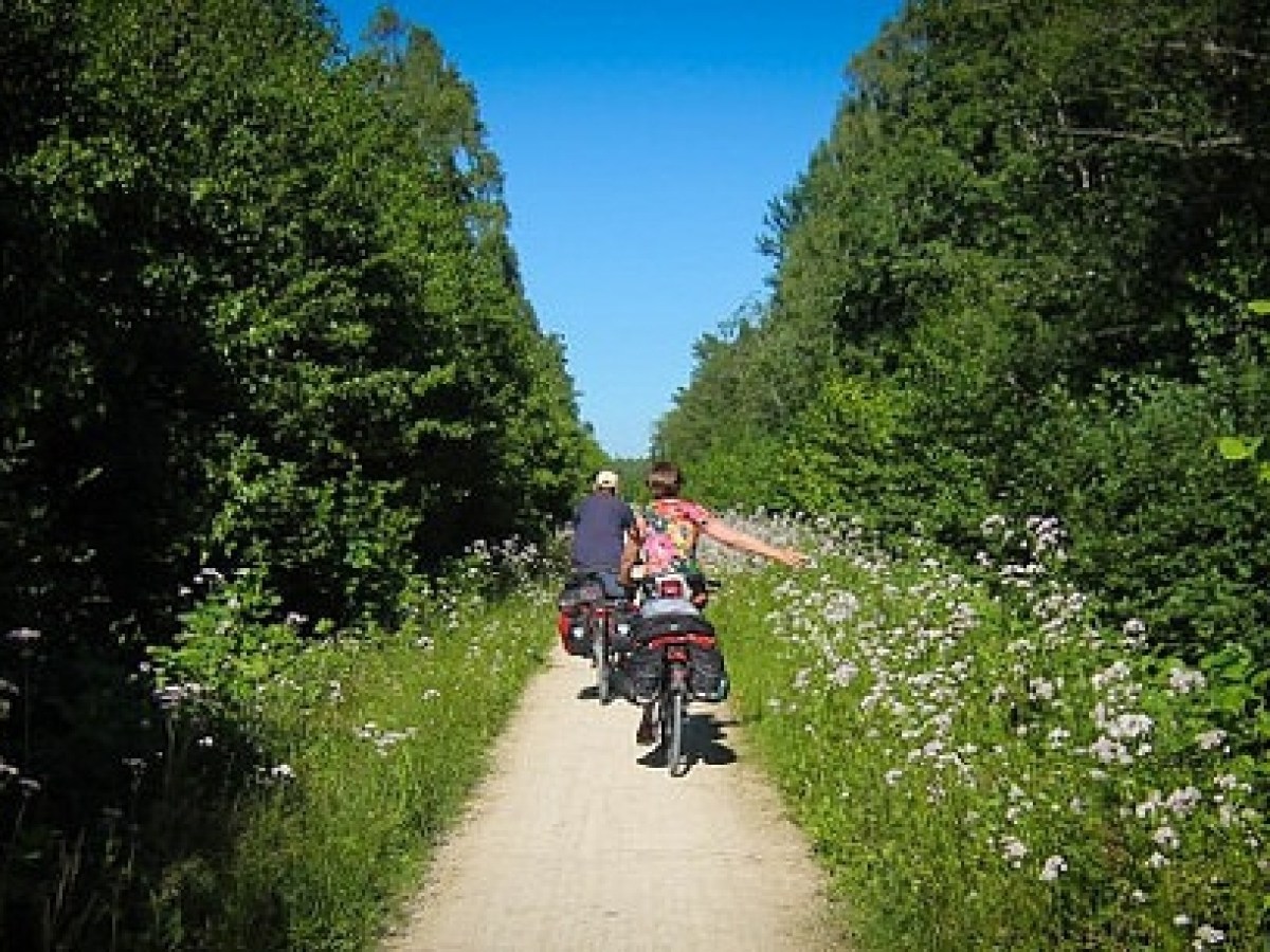 a person riding a motorcycle down a dirt road