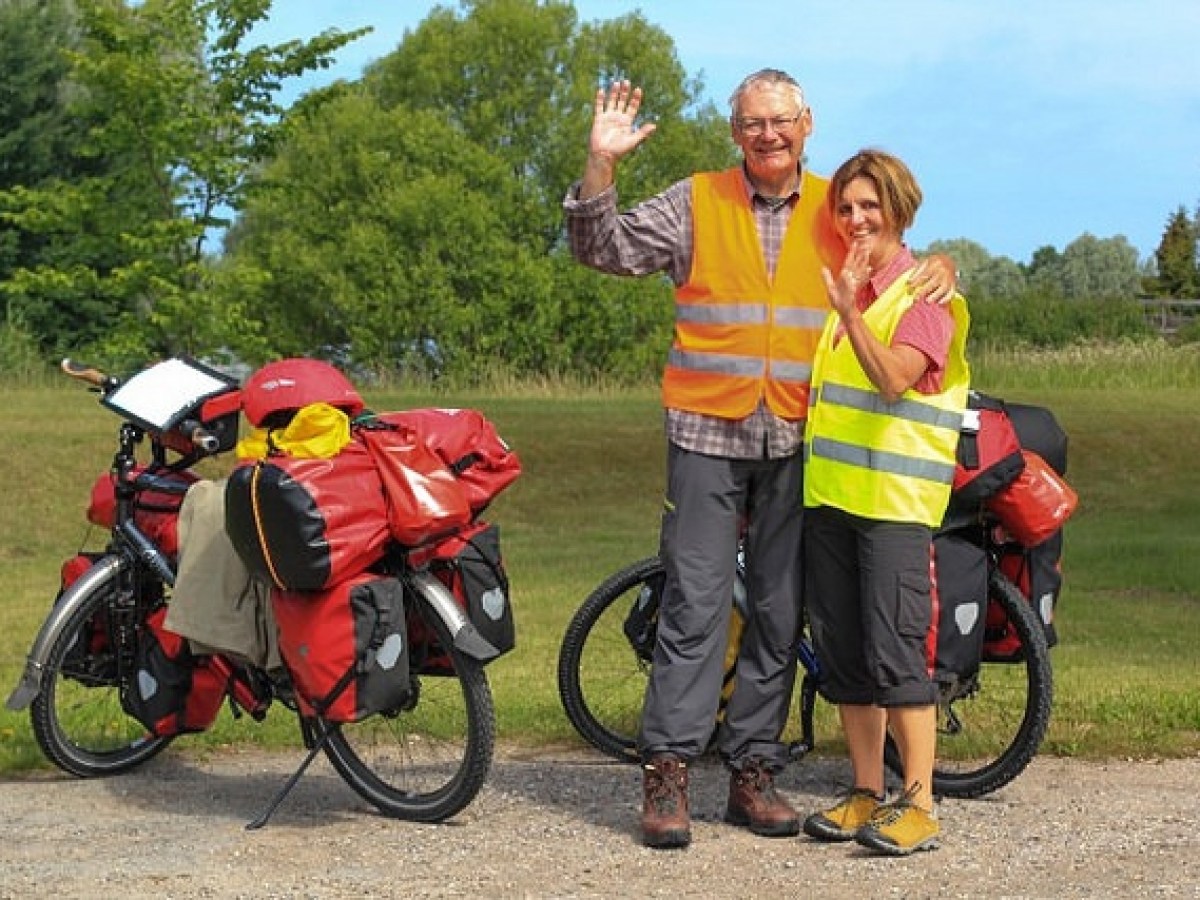 a group of people standing next to a bicycle