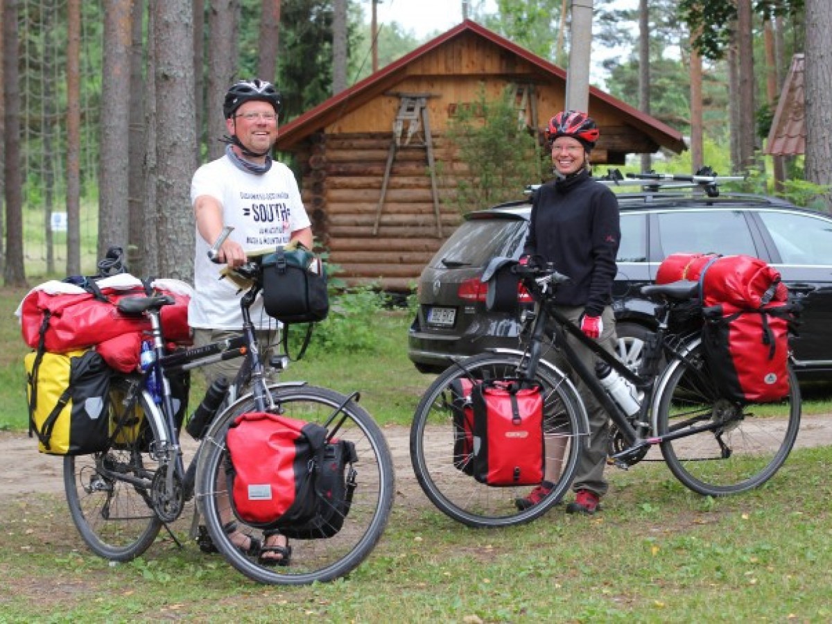 a person standing next to a bicycle