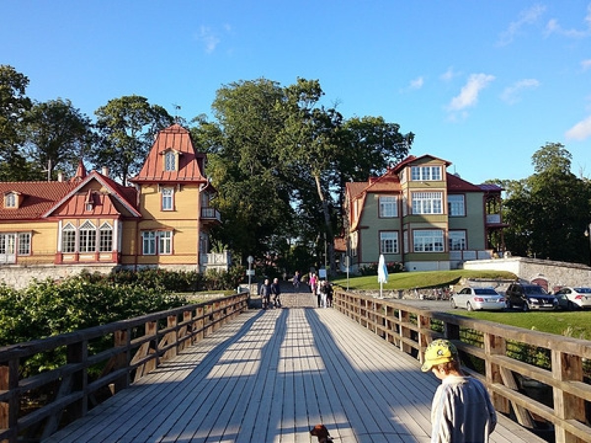 a group of people on a sidewalk in front of a house