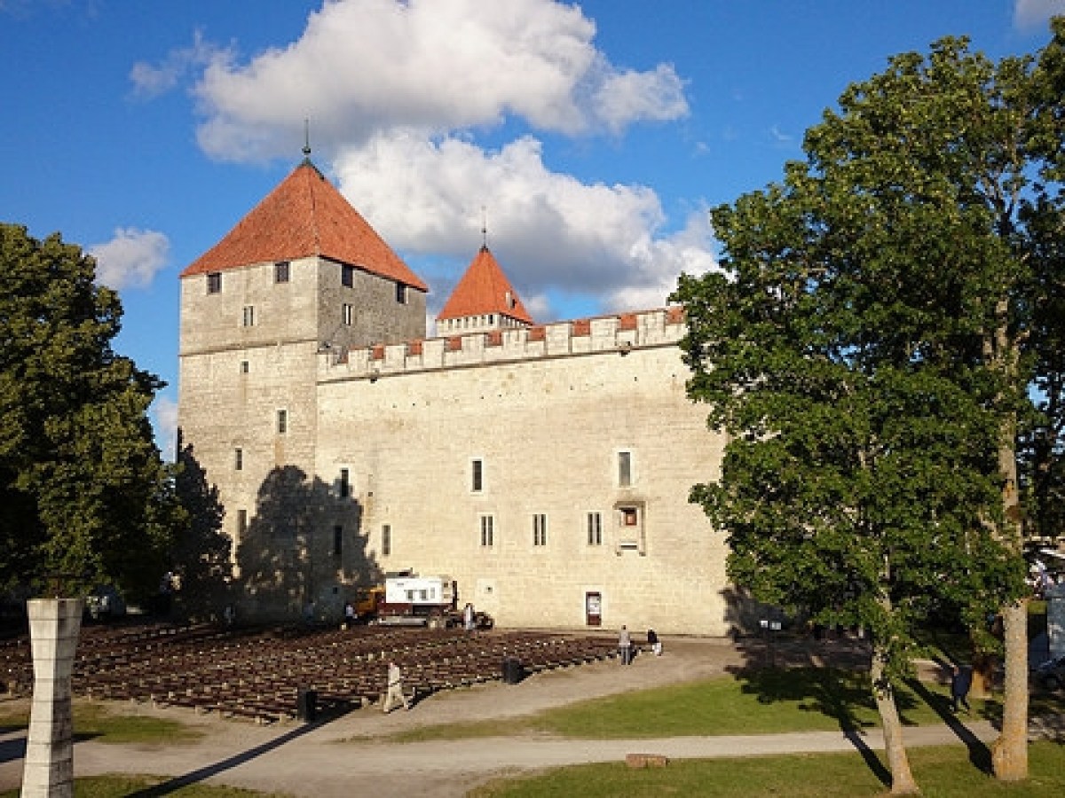 a castle with a clock on the side of a building