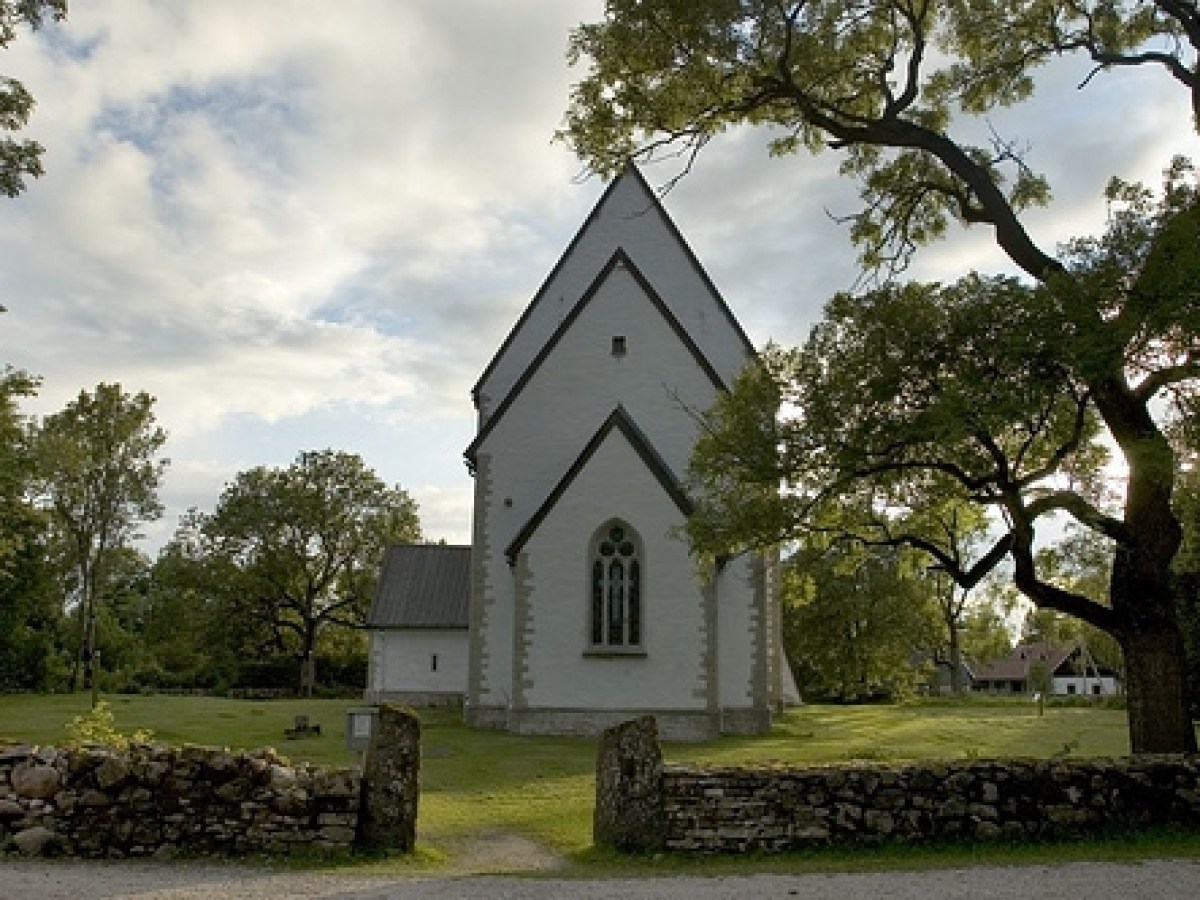 a small clock tower in front of a house