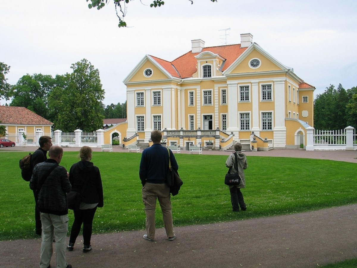 a group of people walking in front of a house