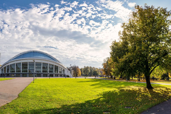a large building with a grassy field
