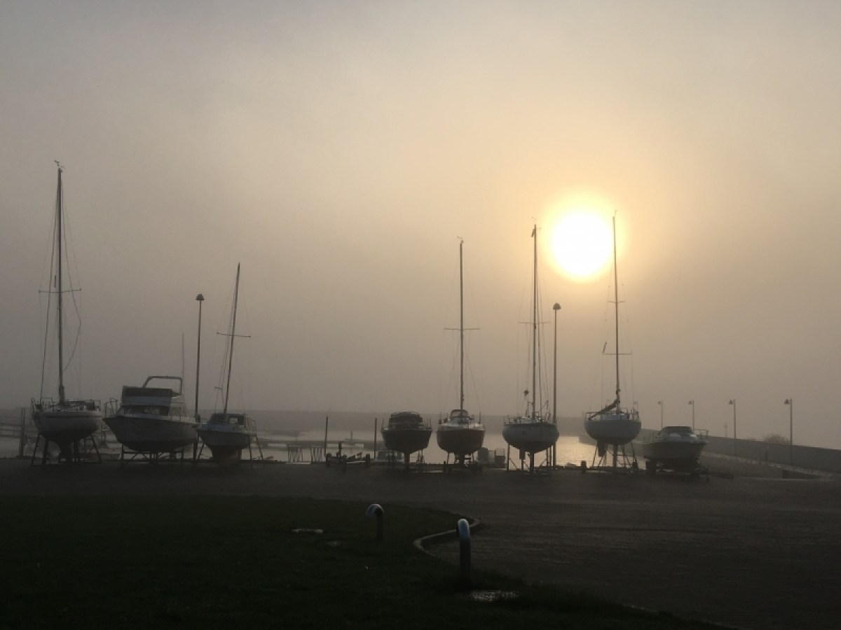a boat is docked next to a body of water