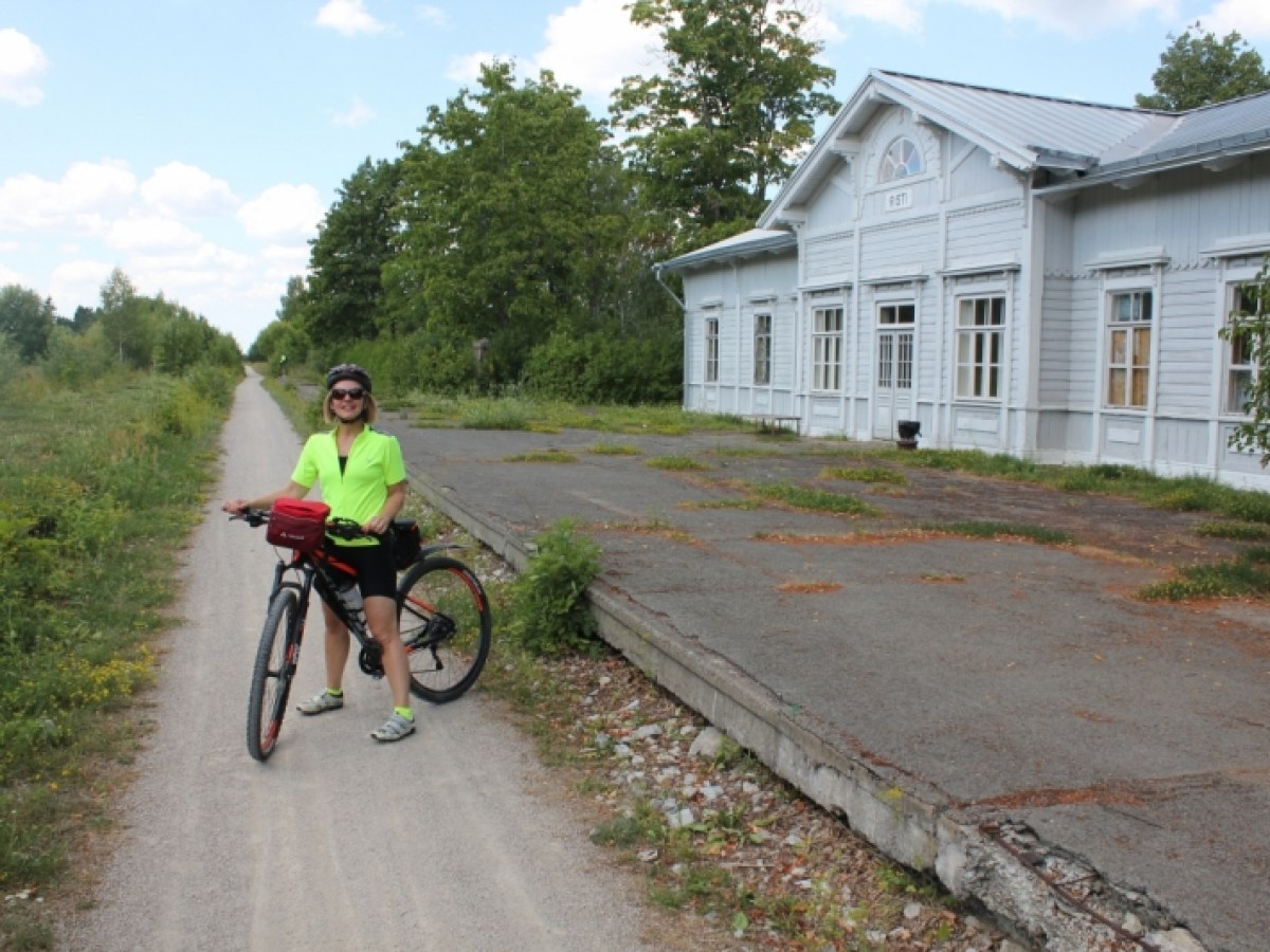 a person riding a bike down a dirt road