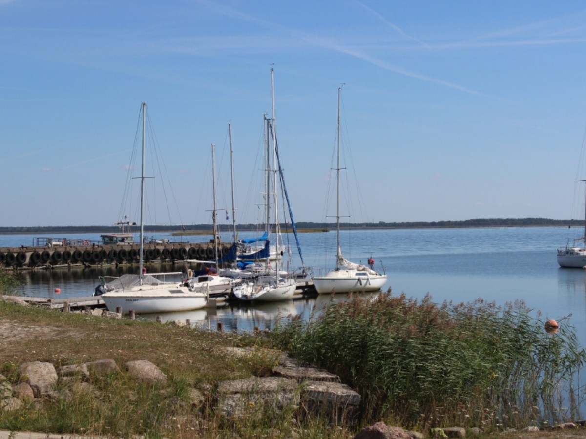 a boat is docked next to a body of water