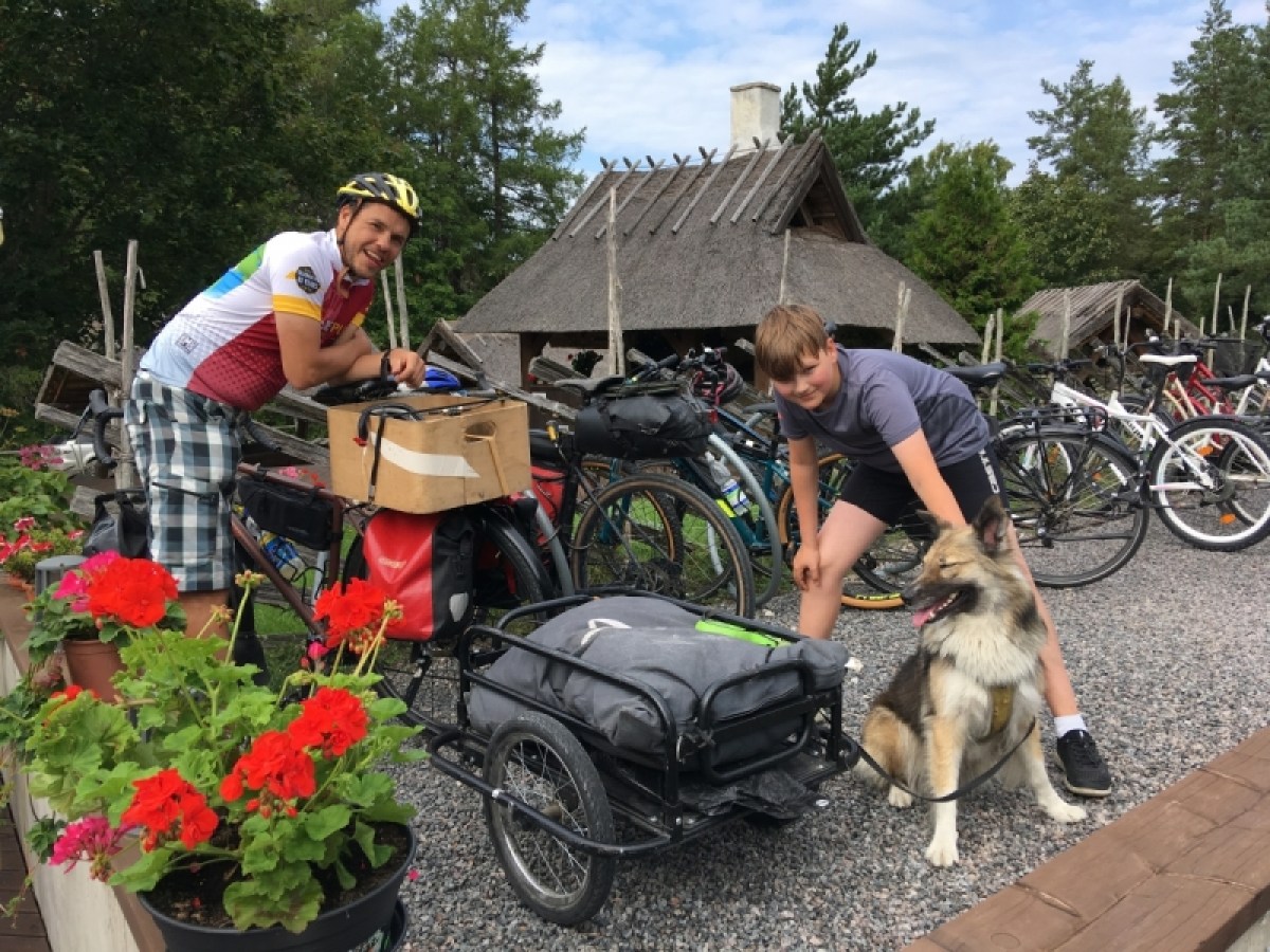a person riding a motorcycle with a dog