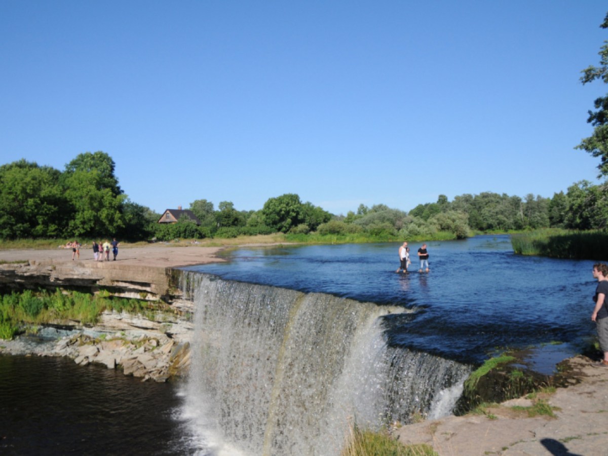 a man standing next to a body of water