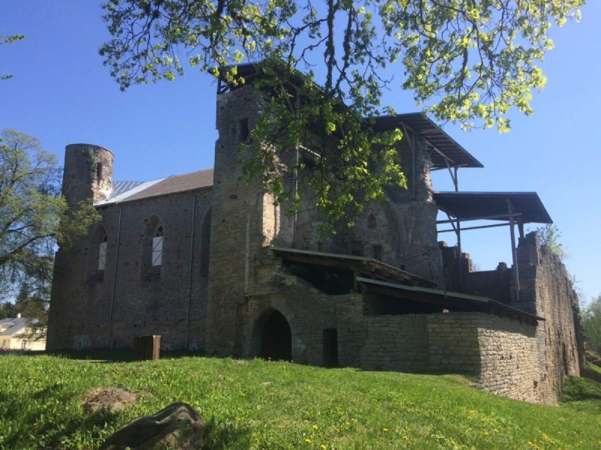 a large brick building with grass and trees