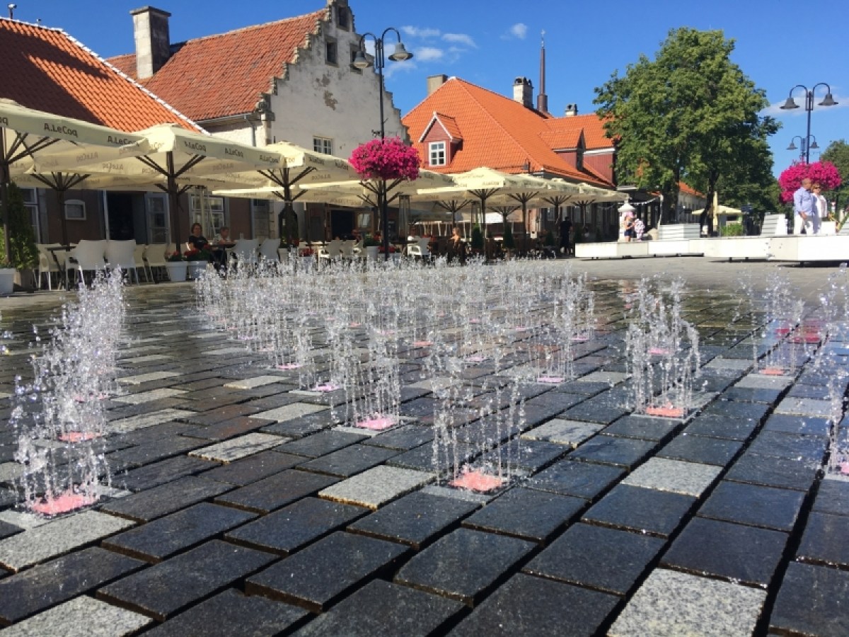 a group of people on a sidewalk near a building