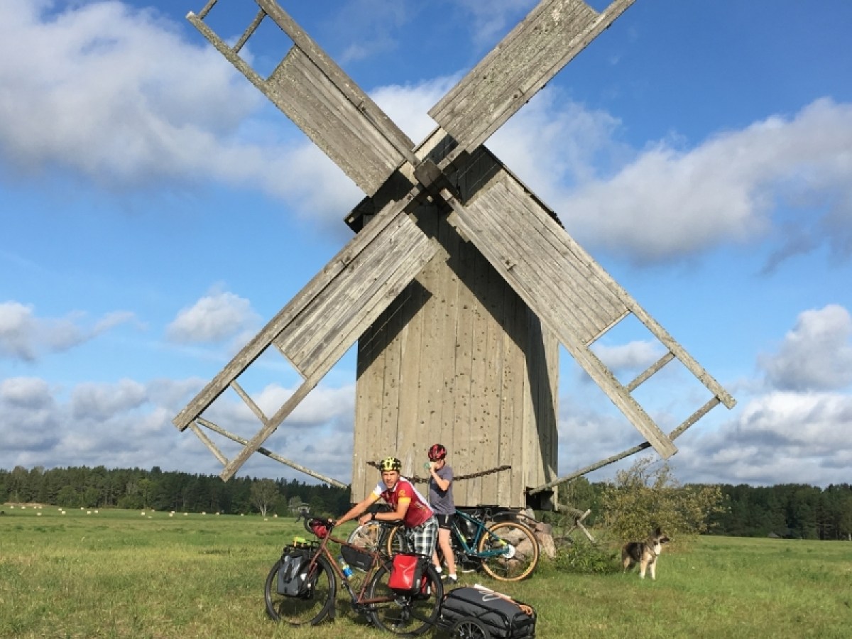 a motorcycle parked in a grassy field with Morgan Lewis Windmill in the background