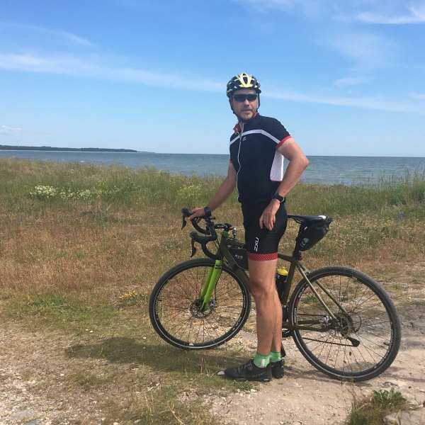 a man riding a bike down a dirt road