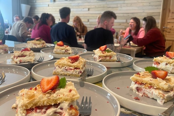 a group of people sitting at a table with a plate of food