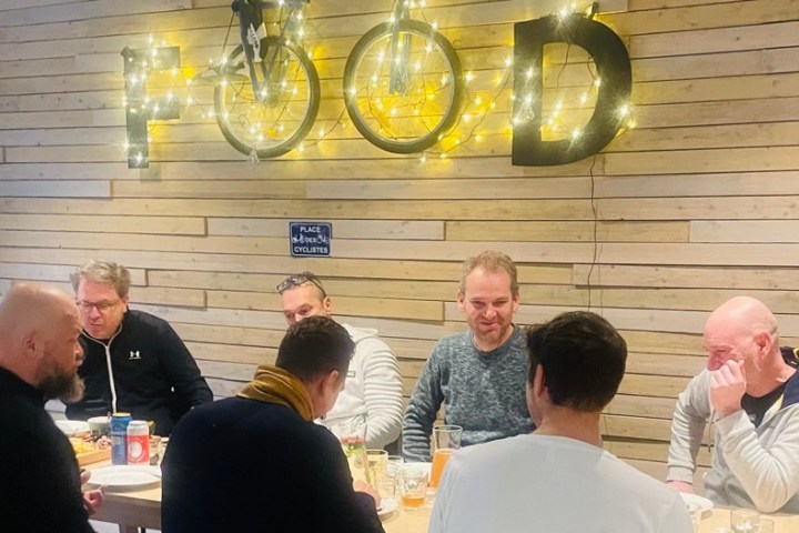 a group of people sitting at a table with wine glasses