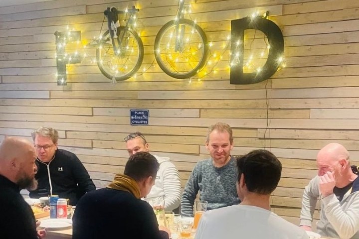 a group of people sitting at a table with wine glasses