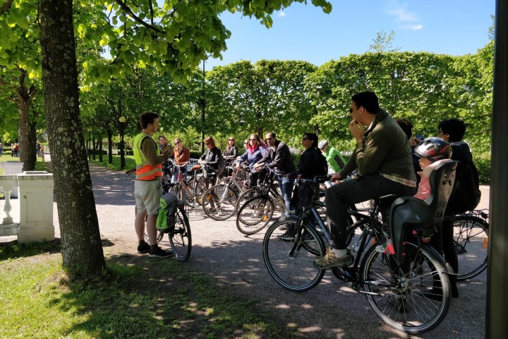 a group of people riding on the back of a bicycle