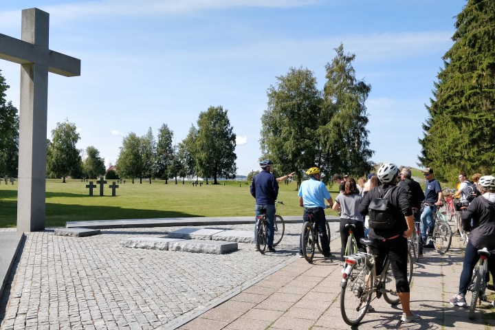 a group of people riding on the back of a bicycle