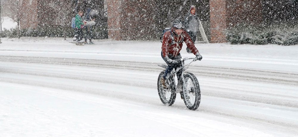 a man riding a bicycle down the street