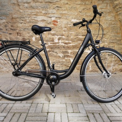 a bicycle parked in front of a brick building