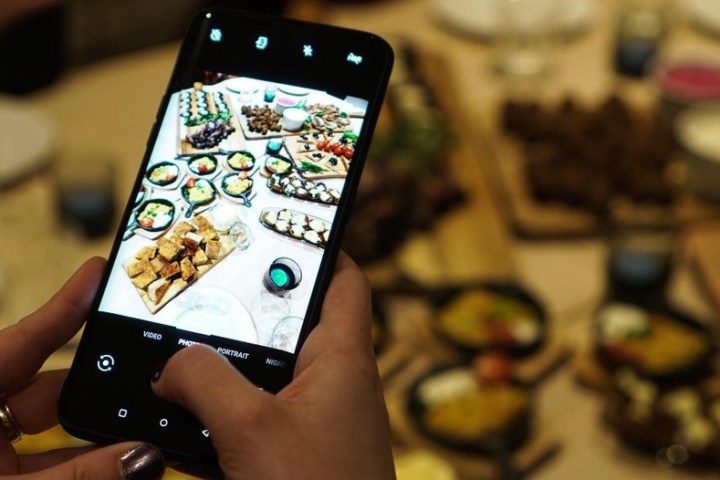 a hand holding a cell phone