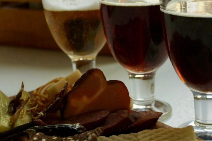 a close up of a plate of food and a glass of wine